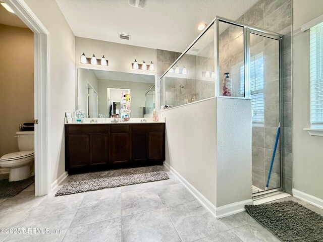 195 Torres Trce, Saint Augustine, FL 32095 - bathroom featuring a stall shower, double vanity, toilet, a textured ceiling, and baseboards
