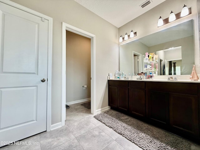195 Torres Trce, Saint Augustine, FL 32095 - bathroom with double vanity, baseboards, and tile patterned flooring