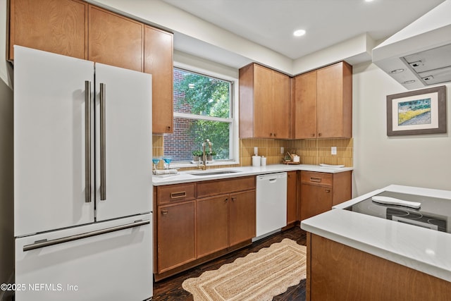 3577 Valencia Rd, Jacksonville, FL 32205 - kitchen with white appliances, dark wood finished floors, a sink, light countertops, and decorative backsplash