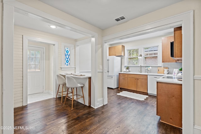 3577 Valencia Rd, Jacksonville, FL 32205 - kitchen with white appliances, a sink, dark wood-type flooring, and light countertops