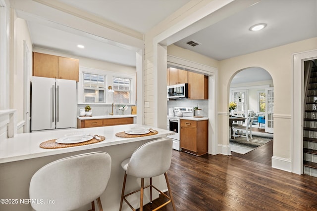 3577 Valencia Rd, Jacksonville, FL 32205 - kitchen featuring white appliances, plenty of natural light, light countertops, dark wood-style flooring, and recessed lighting