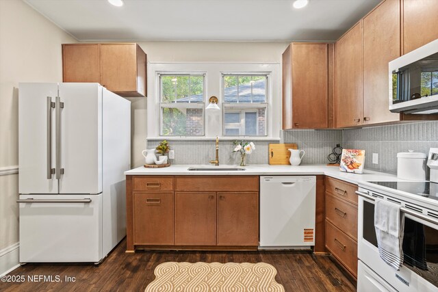 3577 Valencia Rd, Jacksonville, FL 32205 - kitchen featuring white appliances, a sink, light countertops, dark wood finished floors, and recessed lighting