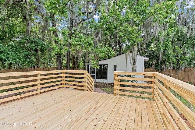 3577 Valencia Rd, Jacksonville, FL 32205 - wooden deck with a sunroom, view of scattered trees, and fence