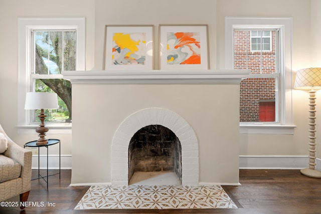 3577 Valencia Rd, Jacksonville, FL 32205 - detailed view of wood finished floors, a brick fireplace, and baseboards