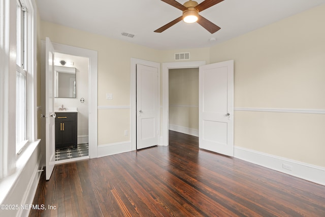 3577 Valencia Rd, Jacksonville, FL 32205 - unfurnished bedroom with dark wood finished floors, a sink, ensuite bath, and baseboards