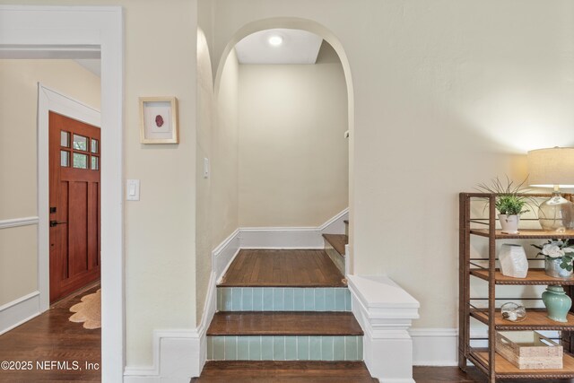 3577 Valencia Rd, Jacksonville, FL 32205 - stairway featuring wood finished floors, arched walkways, and baseboards
