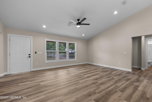 unfurnished living room with a ceiling fan, vaulted ceiling, baseboards, wood finished floors, and recessed lighting