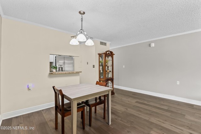 1071 Edgewood Ave S Unit 206, Jacksonville, FL 32205 - dining area with a textured ceiling, dark wood-type flooring, and ornamental molding