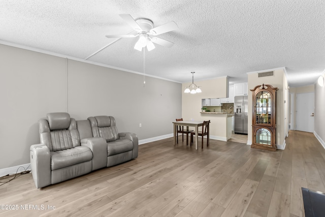 1071 Edgewood Ave S Unit 206, Jacksonville, FL 32205 - living room featuring a ceiling fan, a textured ceiling, a chandelier, and light wood-type flooring