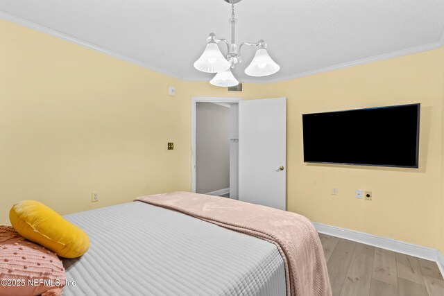 1071 Edgewood Ave S Unit 206, Jacksonville, FL 32205 - bedroom featuring light wood finished floors, crown molding, and a chandelier