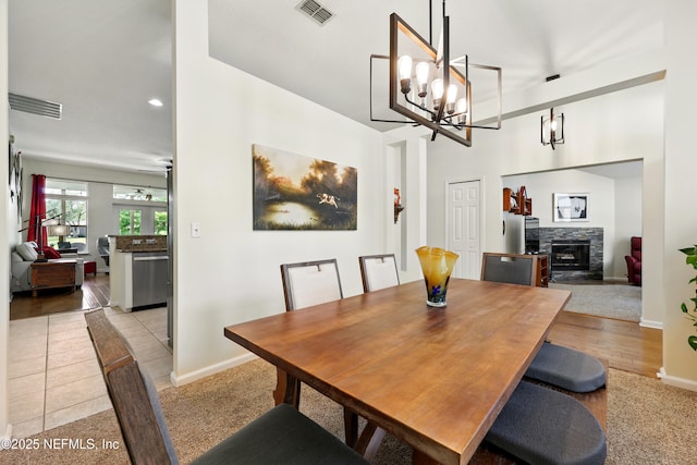 364 Maplewood Dr, Saint Johns, FL 32259 - dining room with baseboards, a stone fireplace, a chandelier, and recessed lighting
