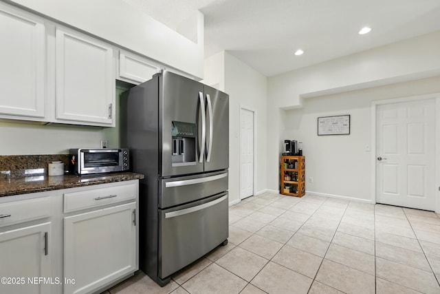 364 Maplewood Dr, Saint Johns, FL 32259 - kitchen with stainless steel fridge, light tile patterned flooring, white cabinets, dark stone counters, and recessed lighting