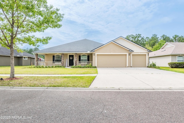 2443 Royal Pointe Dr, Green Cove Springs, FL 32043 - ranch-style home with a front yard, driveway, an attached garage, a porch, and stucco siding