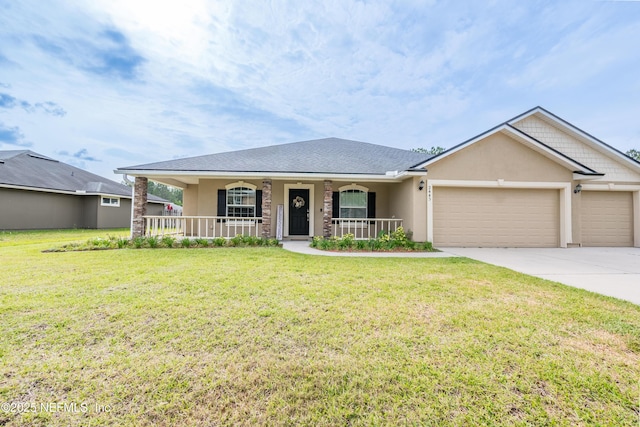 2443 Royal Pointe Dr, Green Cove Springs, FL 32043 - ranch-style home featuring a porch, driveway, an attached garage, stucco siding, and a front yard