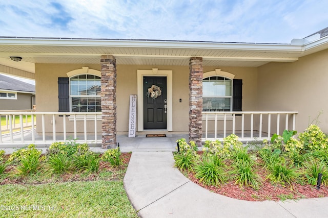2443 Royal Pointe Dr, Green Cove Springs, FL 32043 - entrance to property with stucco siding and covered porch