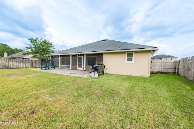 2443 Royal Pointe Dr, Green Cove Springs, FL 32043 - rear view of house with a sunroom, stucco siding, and a trampoline