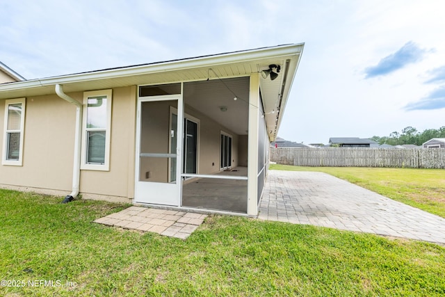 2443 Royal Pointe Dr, Green Cove Springs, FL 32043 - rear view of house featuring a sunroom, a patio, and stucco siding