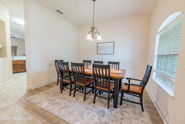2443 Royal Pointe Dr, Green Cove Springs, FL 32043 - dining space with light wood-style floors, a chandelier, and baseboards