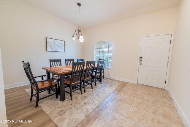 2443 Royal Pointe Dr, Green Cove Springs, FL 32043 - dining room with a chandelier, baseboards, and light wood finished floors