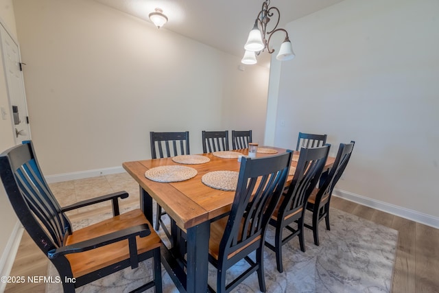 2443 Royal Pointe Dr, Green Cove Springs, FL 32043 - dining area with baseboards, light wood-style flooring, and a chandelier