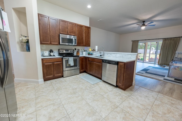 2443 Royal Pointe Dr, Green Cove Springs, FL 32043 - kitchen with appliances with stainless steel finishes, a sink, a ceiling fan, a peninsula, and light countertops