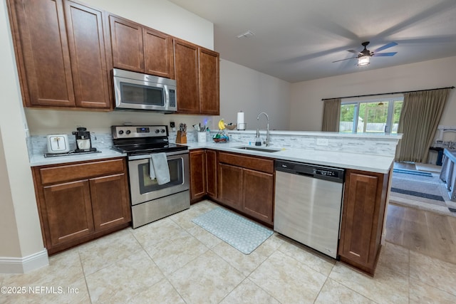 2443 Royal Pointe Dr, Green Cove Springs, FL 32043 - kitchen featuring appliances with stainless steel finishes, a sink, a peninsula, and light countertops