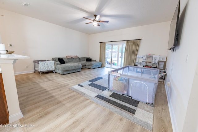 2443 Royal Pointe Dr, Green Cove Springs, FL 32043 - living room featuring wood finished floors, a ceiling fan, and a wood stove