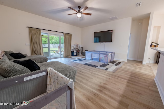 2443 Royal Pointe Dr, Green Cove Springs, FL 32043 - living room with ceiling fan, light wood-style flooring, and baseboards