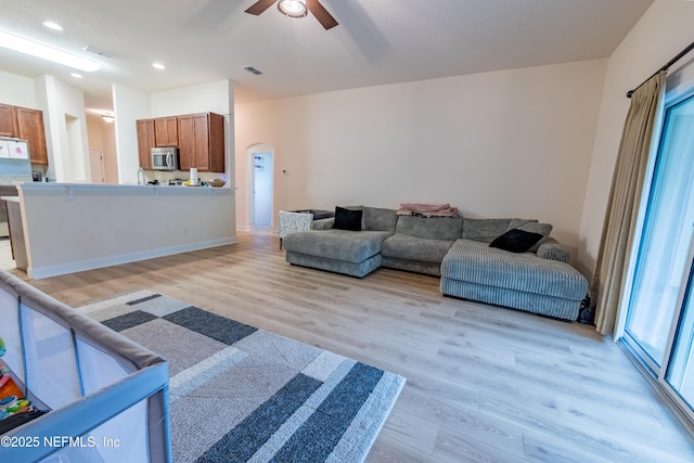2443 Royal Pointe Dr, Green Cove Springs, FL 32043 - living room featuring light wood-style floors, ceiling fan, arched walkways, plenty of natural light, and recessed lighting