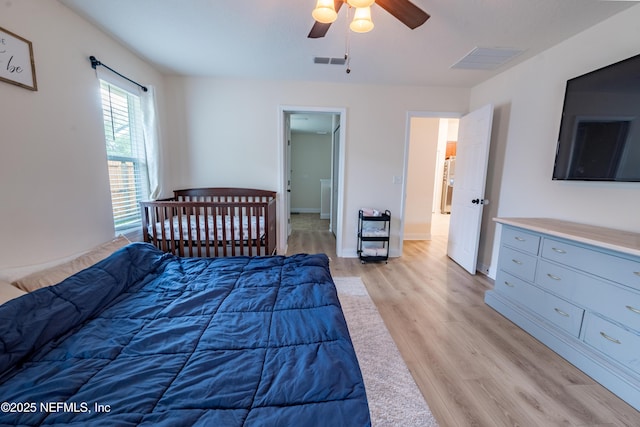 2443 Royal Pointe Dr, Green Cove Springs, FL 32043 - bedroom with light wood-style flooring, ceiling fan, and baseboards