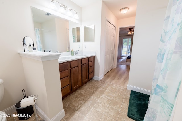 2443 Royal Pointe Dr, Green Cove Springs, FL 32043 - full bathroom featuring double vanity, baseboards, toilet, and tile patterned flooring