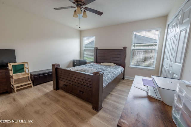 2443 Royal Pointe Dr, Green Cove Springs, FL 32043 - bedroom with light wood-style flooring, a closet, ceiling fan, and baseboards