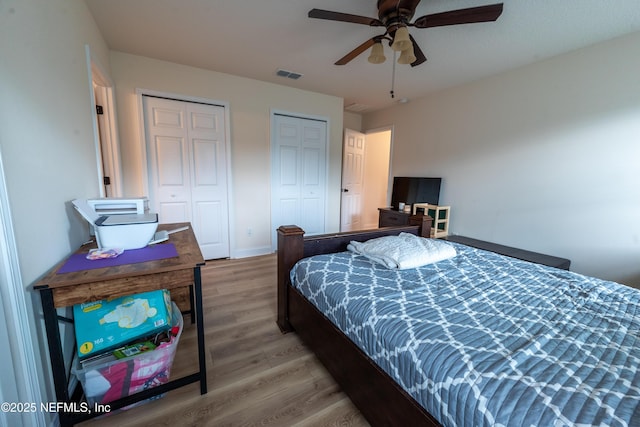 2443 Royal Pointe Dr, Green Cove Springs, FL 32043 - bedroom featuring two closets, light wood-style floors, ceiling fan, and baseboards