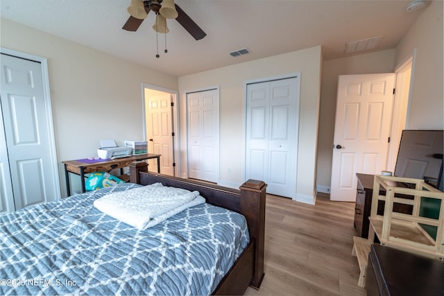 2443 Royal Pointe Dr, Green Cove Springs, FL 32043 - bedroom featuring multiple closets, light wood-style floors, baseboards, and ceiling fan