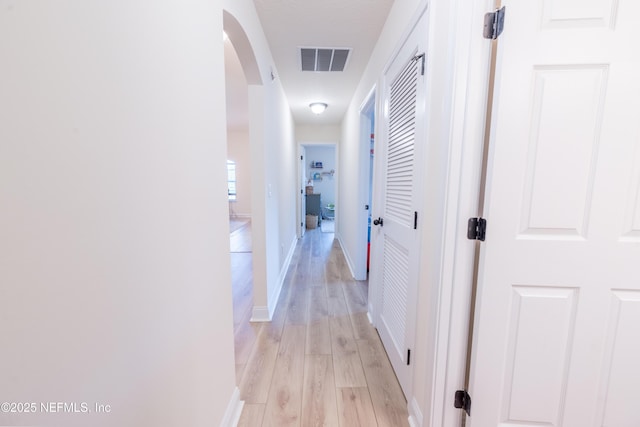 2443 Royal Pointe Dr, Green Cove Springs, FL 32043 - corridor featuring arched walkways, light wood-style flooring, and baseboards