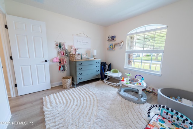 2443 Royal Pointe Dr, Green Cove Springs, FL 32043 - bedroom featuring wood finished floors and baseboards