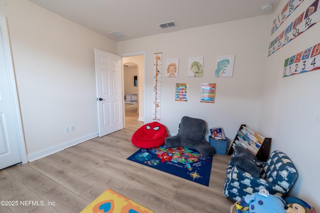 2443 Royal Pointe Dr, Green Cove Springs, FL 32043 - playroom featuring wood finished floors, arched walkways, and baseboards