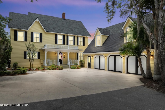 195 S Roscoe Blvd, Ponte Vedra Beach, FL 32082 - view of front of home with covered porch, concrete driveway, a chimney, and roof with shingles