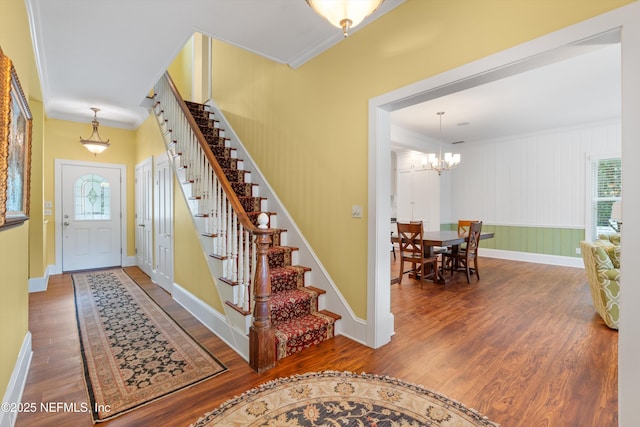 195 S Roscoe Blvd, Ponte Vedra Beach, FL 32082 - entryway with crown molding, stairs, wood finished floors, a chandelier, and baseboards