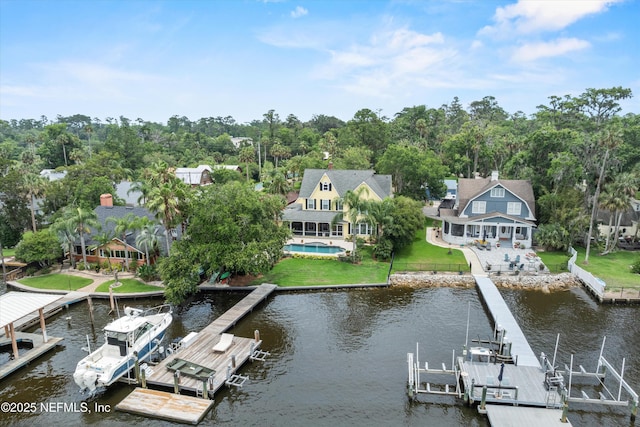 195 S Roscoe Blvd, Ponte Vedra Beach, FL 32082 - dock featuring boat lift, a water view, an outdoor pool, and view of wooded area