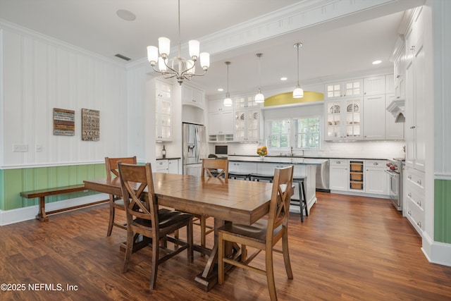 195 S Roscoe Blvd, Ponte Vedra Beach, FL 32082 - dining room featuring ornamental molding, dark wood-style floors, wine cooler, a chandelier, and recessed lighting