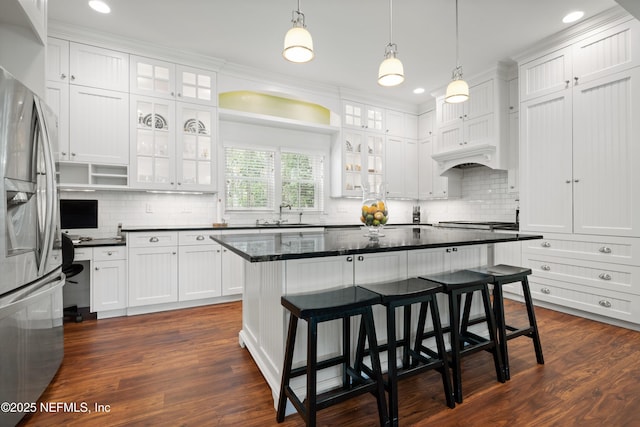 195 S Roscoe Blvd, Ponte Vedra Beach, FL 32082 - kitchen featuring white cabinetry, stainless steel refrigerator with ice dispenser, a kitchen breakfast bar, backsplash, and recessed lighting