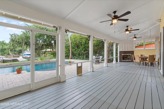 195 S Roscoe Blvd, Ponte Vedra Beach, FL 32082 - unfurnished sunroom featuring a fireplace, outdoor dining area, ceiling fan, and healthy amount of natural light