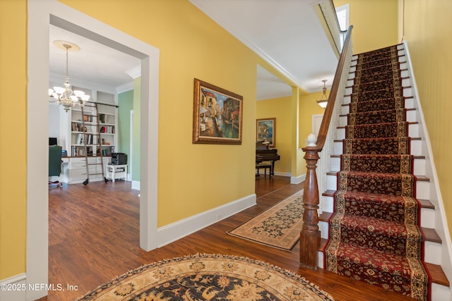 195 S Roscoe Blvd, Ponte Vedra Beach, FL 32082 - staircase with crown molding, wood finished floors, a chandelier, baseboards, and built in shelves