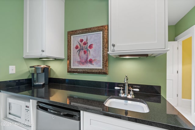 195 S Roscoe Blvd, Ponte Vedra Beach, FL 32082 - kitchen featuring stainless steel dishwasher, a sink, white microwave, and white cabinets