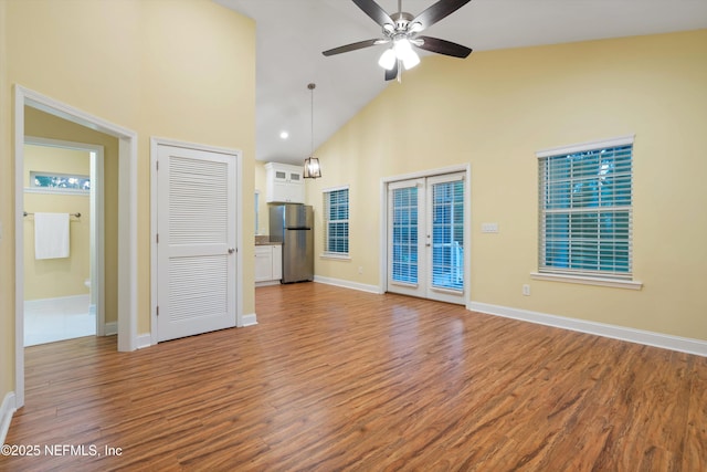 195 S Roscoe Blvd, Ponte Vedra Beach, FL 32082 - unfurnished living room with high vaulted ceiling, french doors, light wood finished floors, ceiling fan, and baseboards