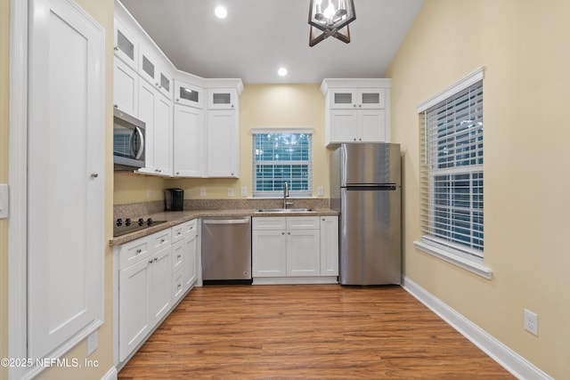 195 S Roscoe Blvd, Ponte Vedra Beach, FL 32082 - kitchen featuring stainless steel appliances, a sink, white cabinets, wood finished floors, and recessed lighting
