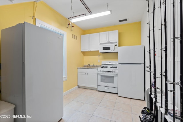 195 S Roscoe Blvd, Ponte Vedra Beach, FL 32082 - kitchen with white appliances, white cabinets, light tile patterned floors, and a sink