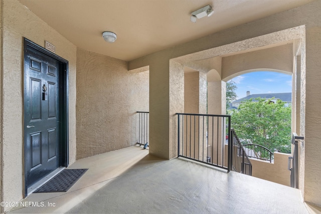 1655 The Greens Way Unit 2432, Jacksonville Beach, FL 32250 - property entrance featuring a balcony and stucco siding