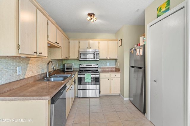 1655 The Greens Way Unit 2432, Jacksonville Beach, FL 32250 - kitchen with appliances with stainless steel finishes, a sink, decorative backsplash, and light tile patterned floors